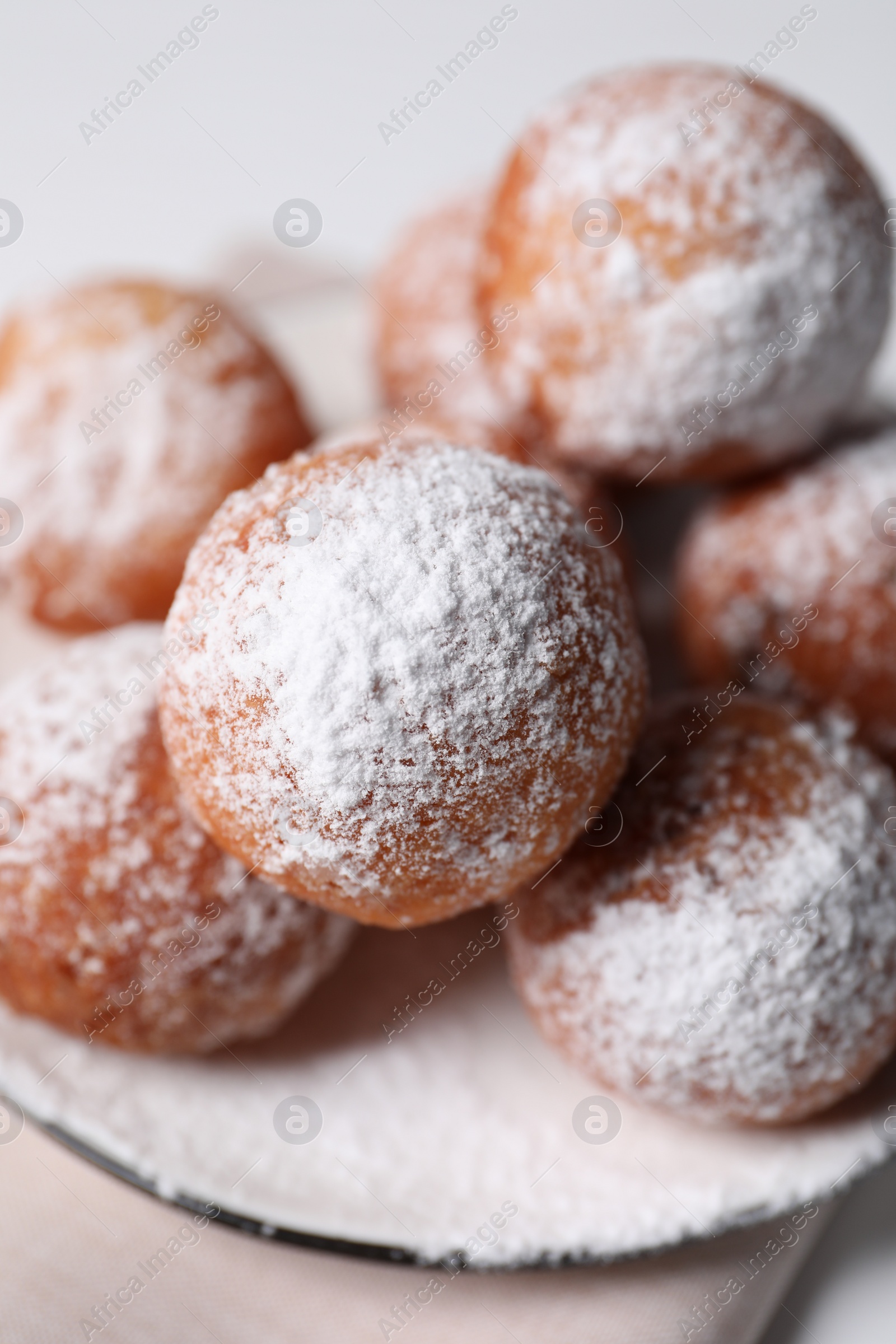 Photo of Delicious sweet buns with powdered sugar on table, closeup