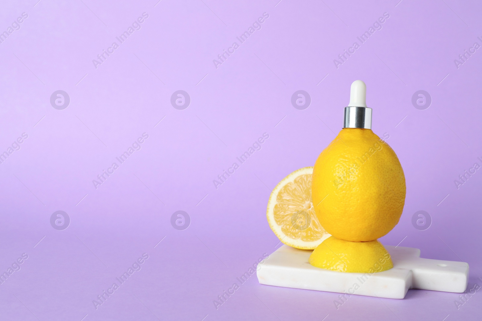 Photo of Lemon with dropper on lilac background, space for text. Skin care product rich in vitamin C