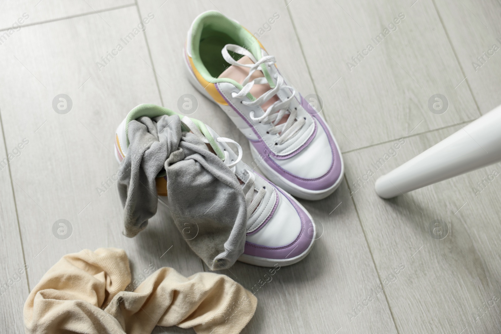 Photo of Color dirty socks and sneakers on floor, above view