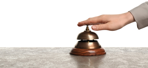 Woman ringing hotel service bell at grey stone table