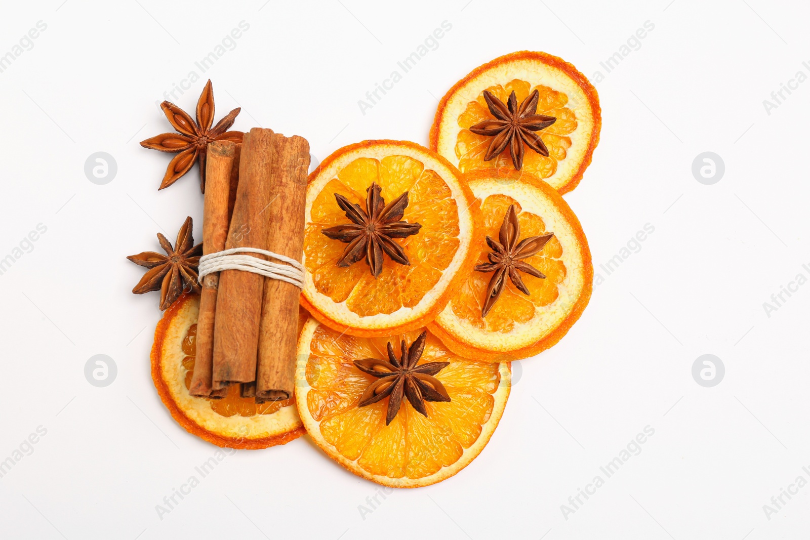 Photo of Dry orange slices, anise stars and cinnamon sticks on white background, flat lay