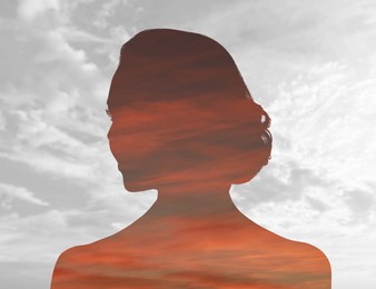 Image of Silhouette of woman and beautiful sunset sky, double exposure