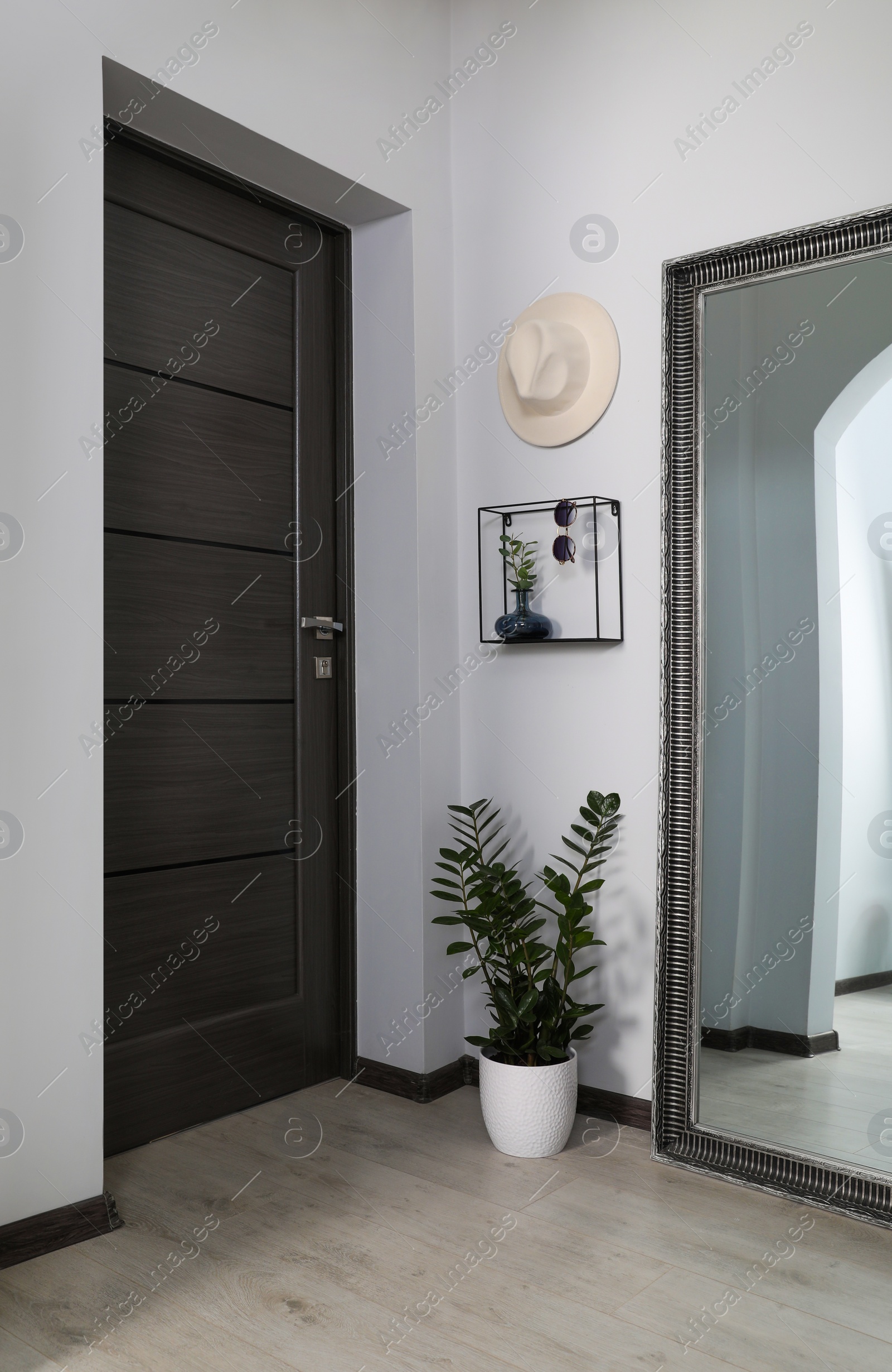 Photo of Modern hallway interior with large mirror near door