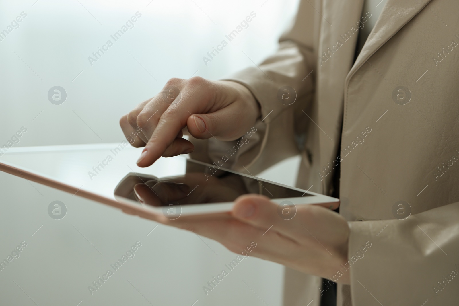 Photo of Closeup view of woman using modern tablet on blurred background