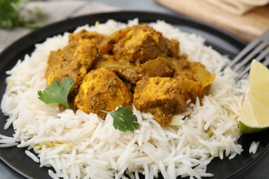 Photo of Delicious chicken curry with rice on table, closeup