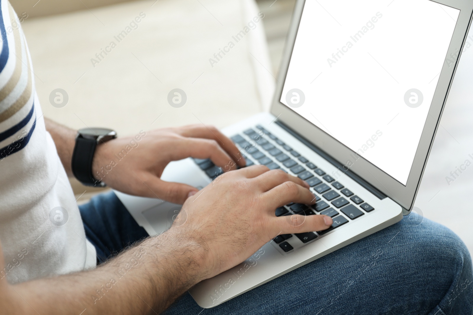 Photo of Man working on modern laptop at home, closeup