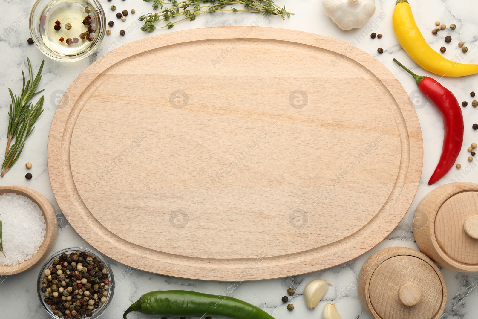 Photo of Wooden cutting board and spices on white marble table, flat lay. Space for text
