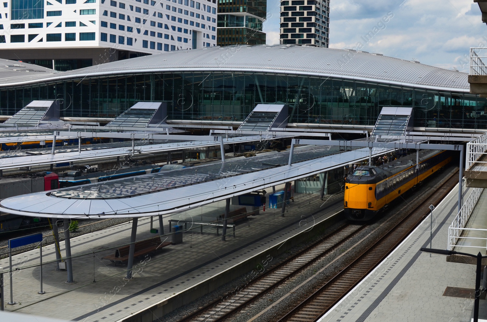 Photo of Railway lines and modern train on sunny day