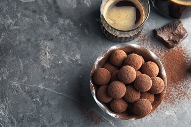 Photo of Flat lay composition with tasty chocolate truffles on grey background, space for text