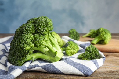 Photo of Fresh green broccoli on wooden table, closeup. Organic food