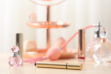 Different makeup products on dressing table, closeup