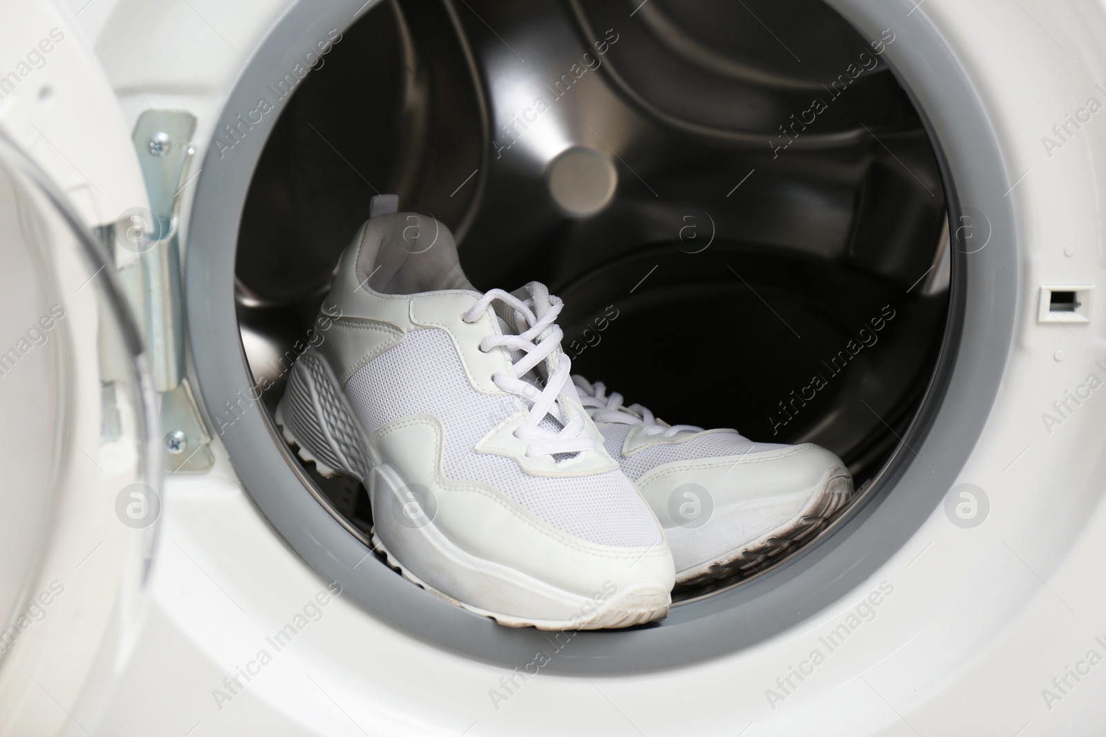 Photo of Clean sports shoes in washing machine drum