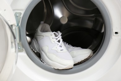 Photo of Clean sports shoes in washing machine drum