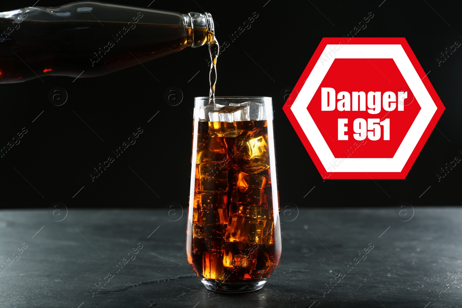 Image of Caution about using of aspartame in product. Warning sign with artificial sweetener code (E951) and word Danger. Pouring soda drink containing sugar substitute against black background