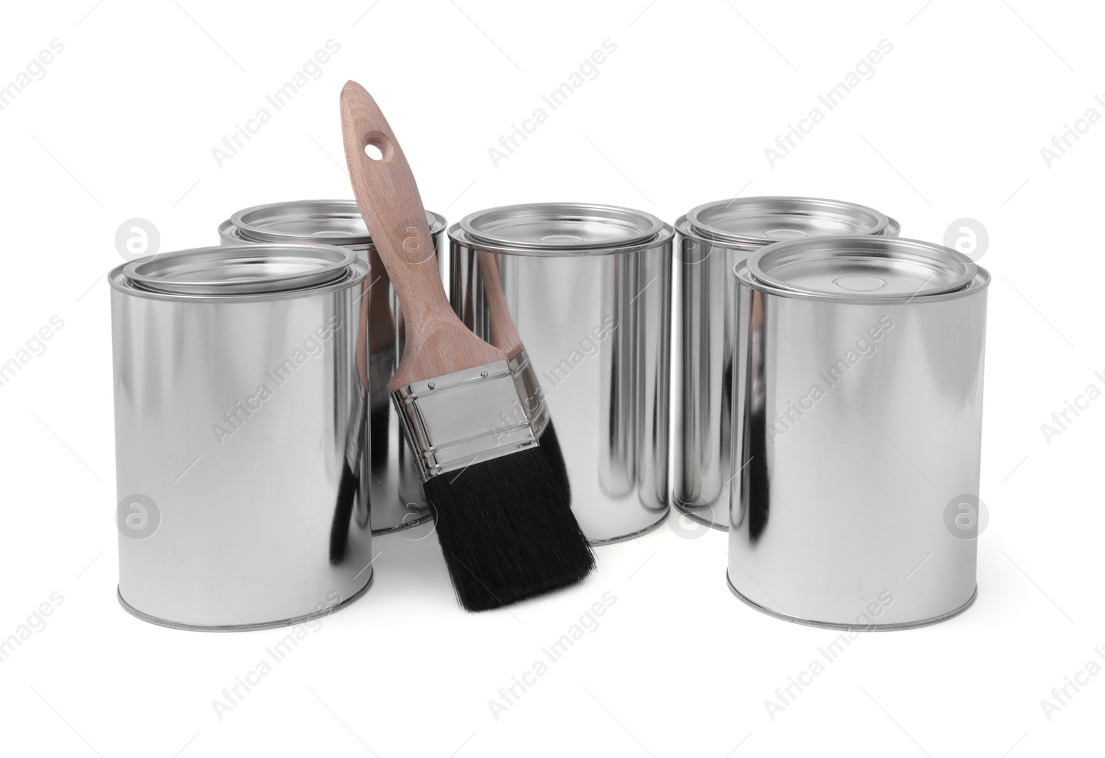 Photo of Cans of paints and brush on white background