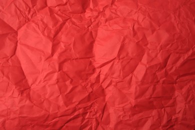 Photo of Sheet of crumpled red paper as background, top view
