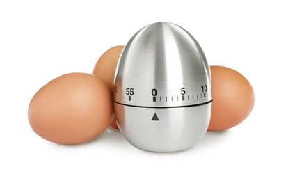 Kitchen timer and chicken eggs on white background