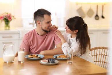 Lovely couple spending time together during breakfast at home