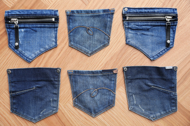 Photo of Flat lay composition with jeans pockets on table