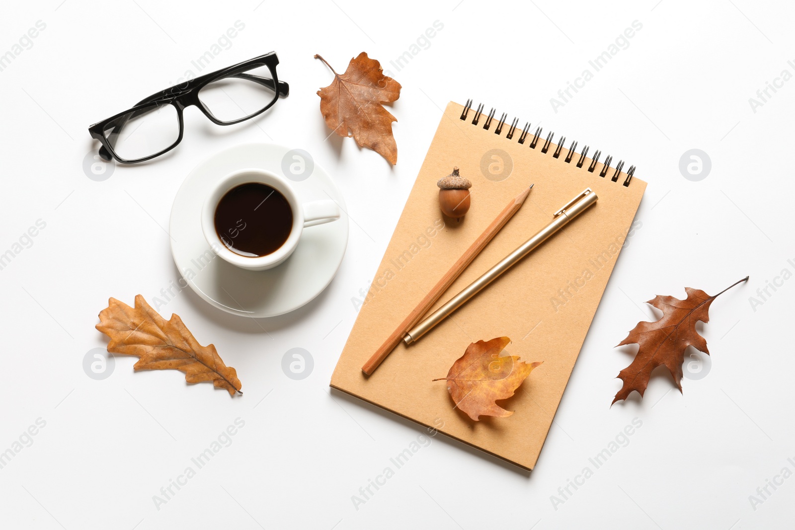 Photo of Flat lay composition with notebook, cup of coffee and autumn leaves on white background