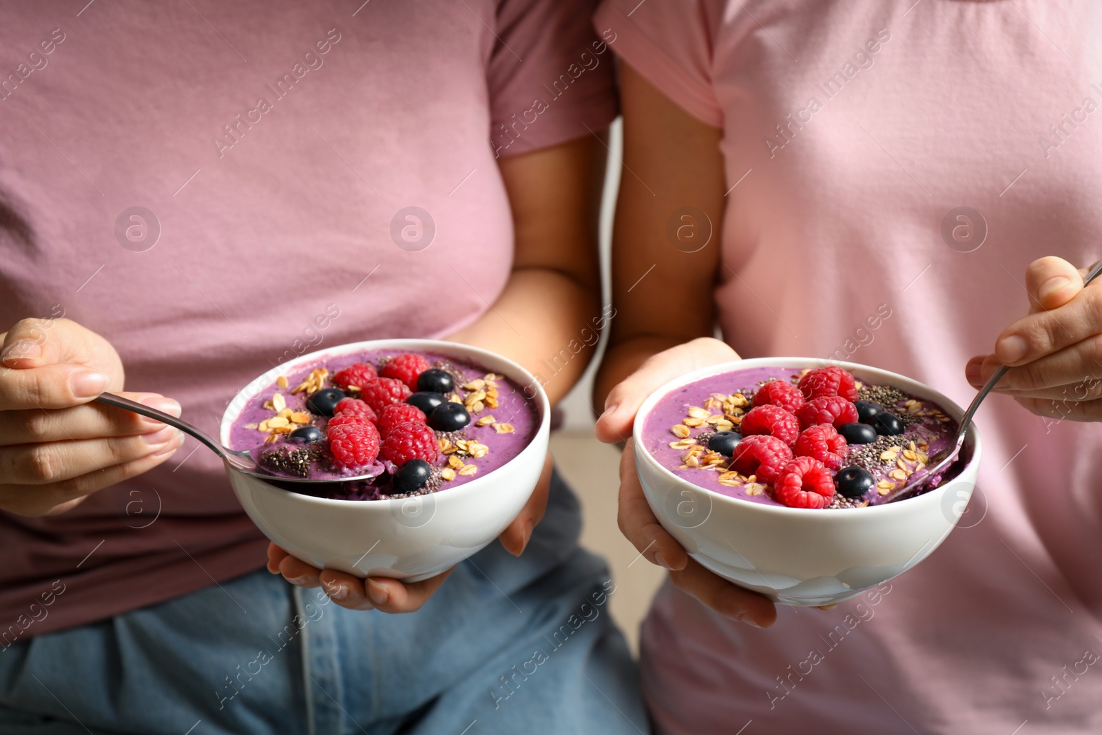 Photo of Women with tasty natural acai smoothie, closeup