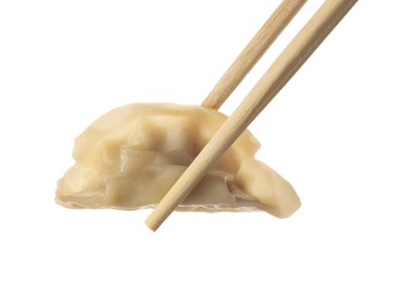 Photo of Chopsticks with delicious gyoza (asian dumpling) isolated on white