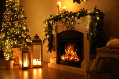 Photo of Beautiful room interior with fireplace and Christmas decor in evening