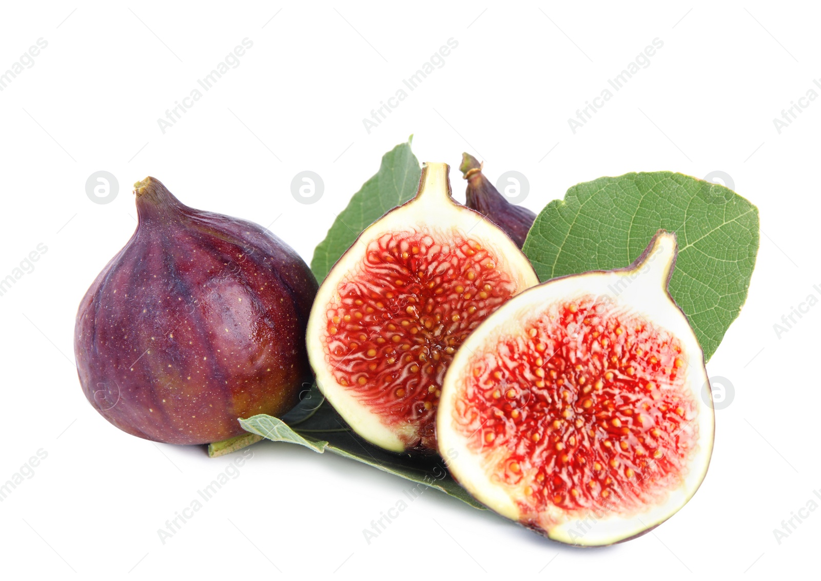 Photo of Fresh juicy purple figs and green leaves on white background