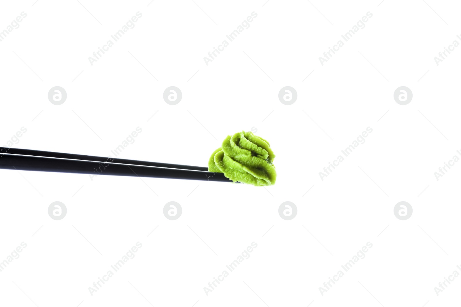 Photo of Chopsticks with swirl of wasabi paste isolated on white