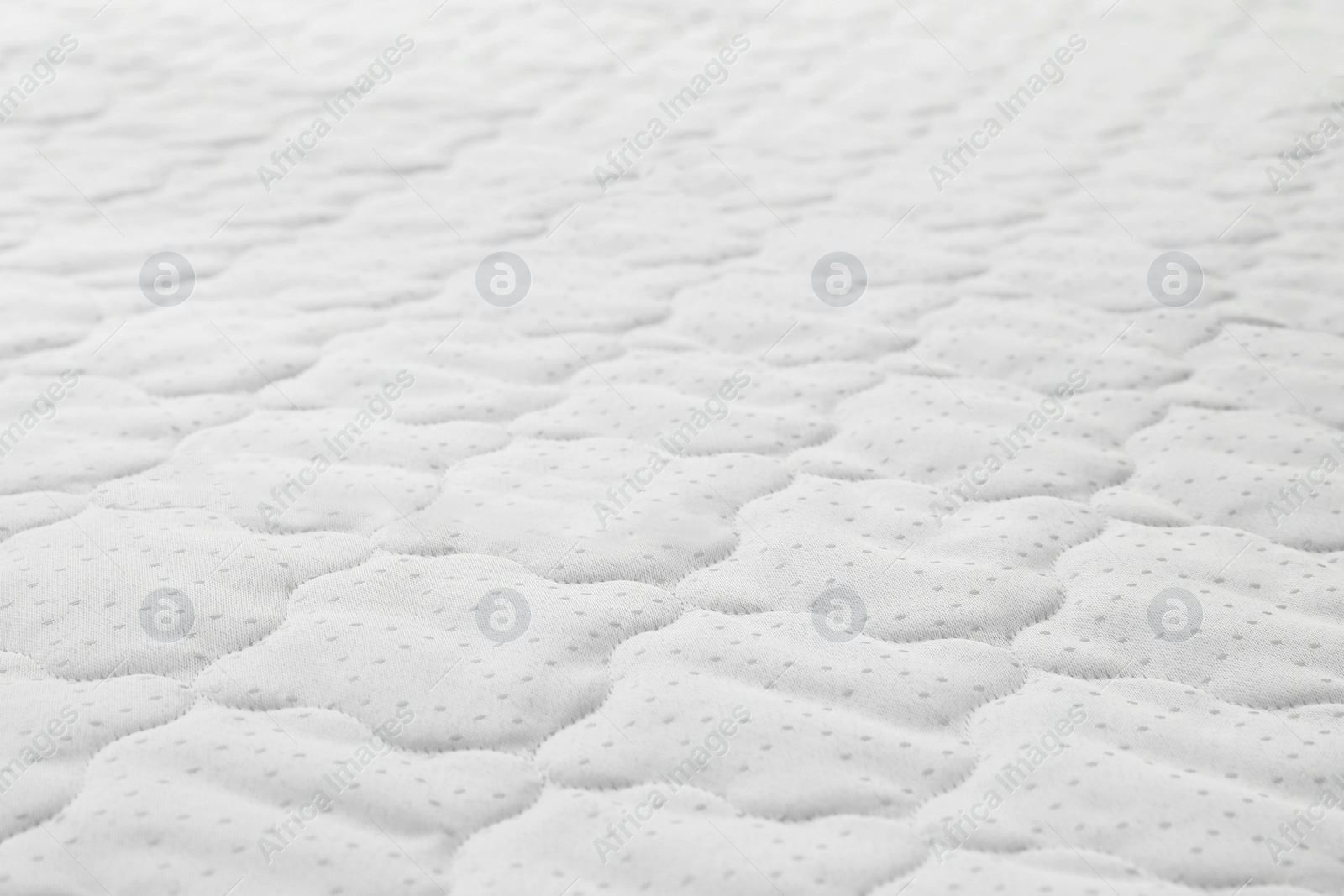 Photo of New light green mattress as background, closeup