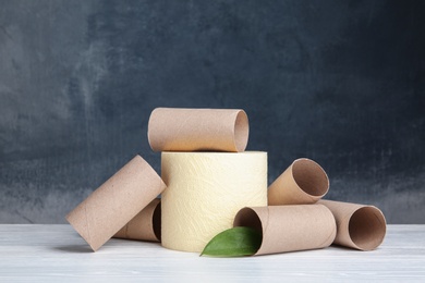 Composition with full and empty toilet paper rolls on table