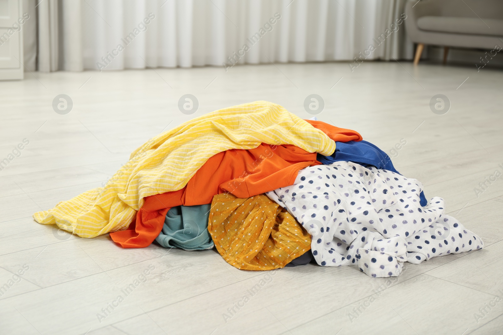 Photo of Pile of dirty clothes on floor indoors