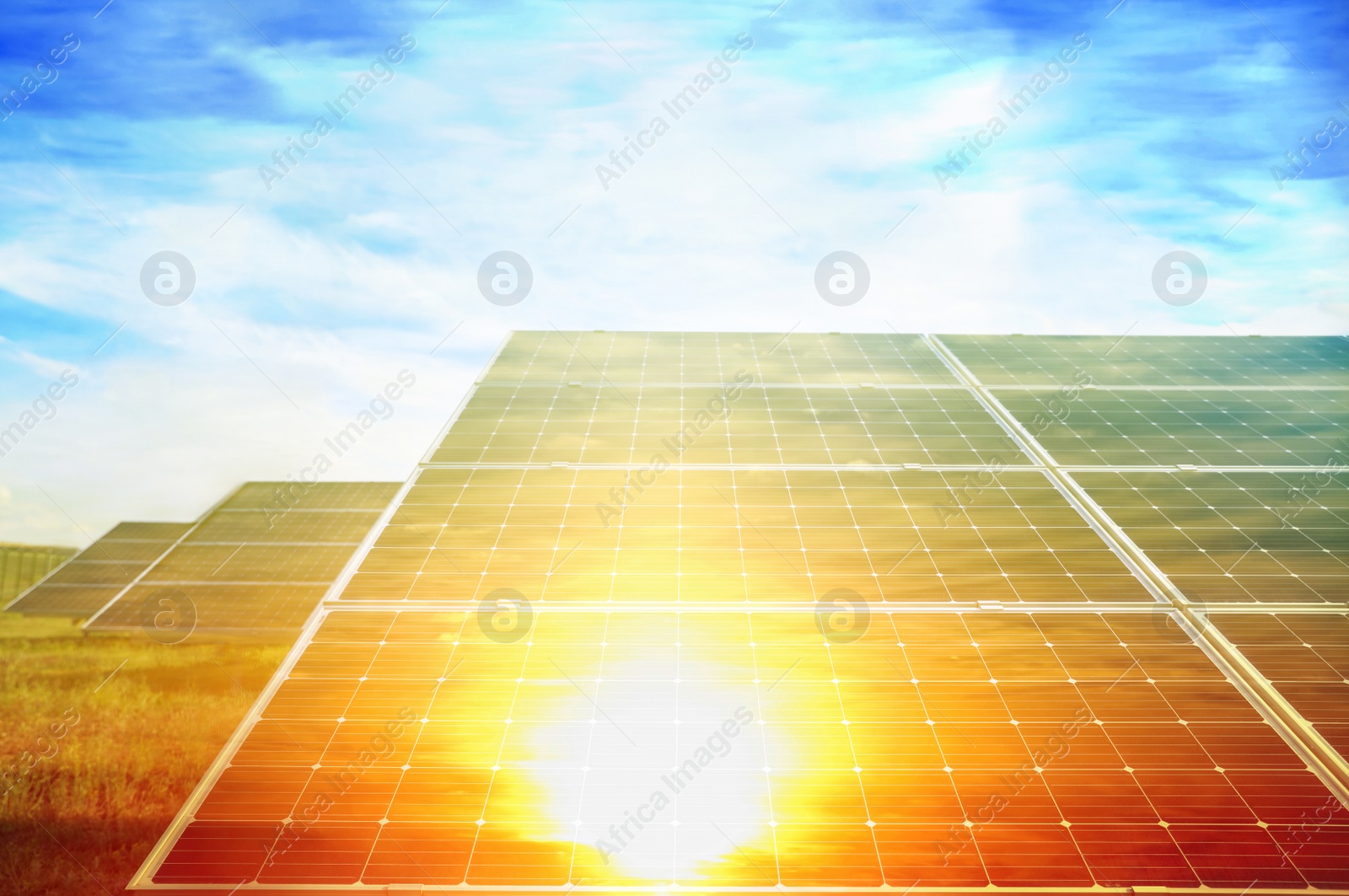 Image of Sunlit solar panels against blue sky. Alternative energy source