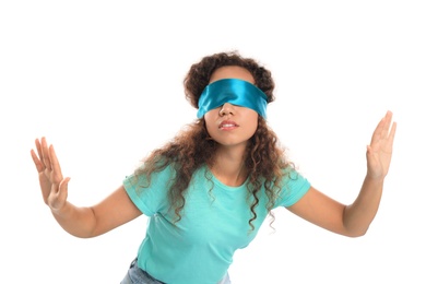 Photo of Young African-American woman with light blue blindfold on white background