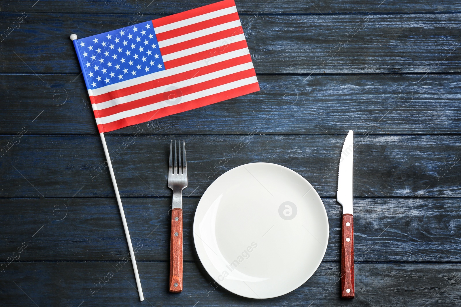 Photo of Patriotic table setting with USA flag on wooden background, flat lay