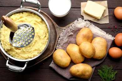 Flat lay composition with tasty mashed potatoes and ingredients on wooden table