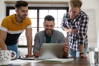 Happy friends working together in modern office