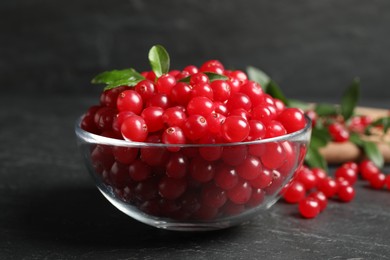 Fresh cranberry in bowl on dark grey table