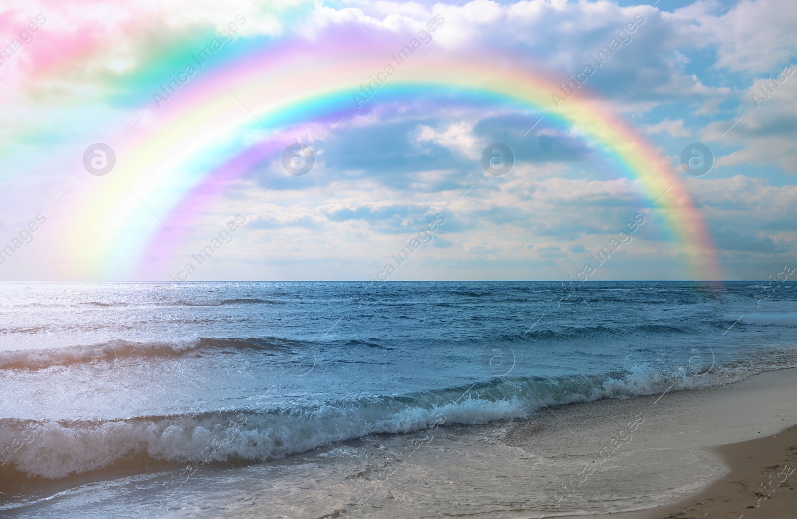 Image of Beautiful view of colorful rainbow in sky over sea