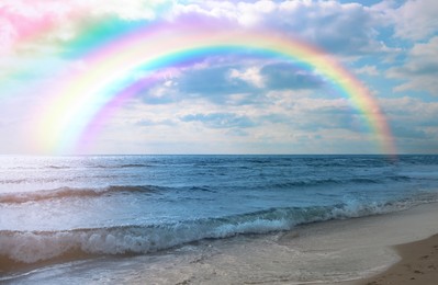 Image of Beautiful view of colorful rainbow in sky over sea