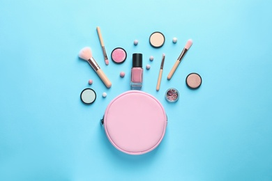 Photo of Makeup products with cosmetic bag on color background