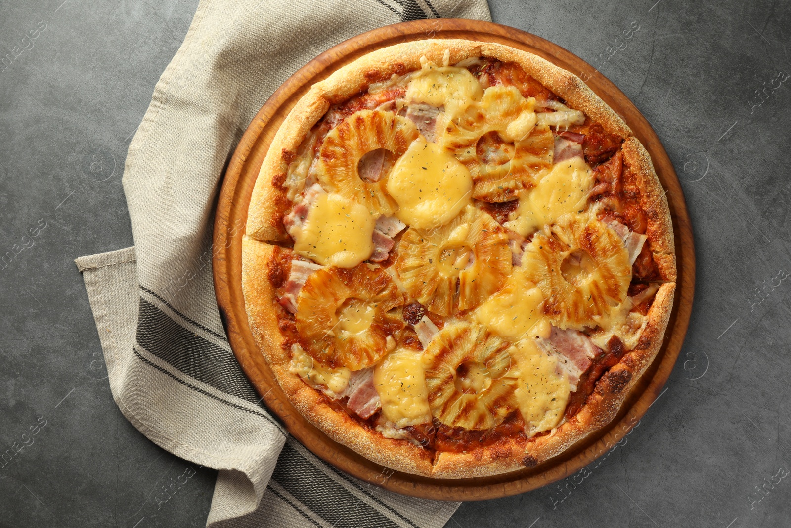 Photo of Delicious pineapple pizza on gray table, top view