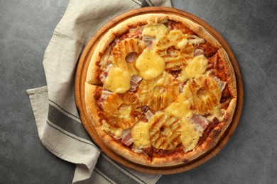 Photo of Delicious pineapple pizza on gray table, top view