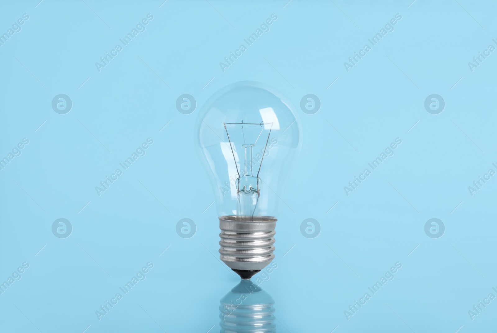 Photo of New modern light bulb on color background