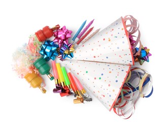 Party crackers and different festive items on white background, top view