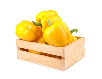 Photo of Crate of ripe yellow bell peppers isolated on white