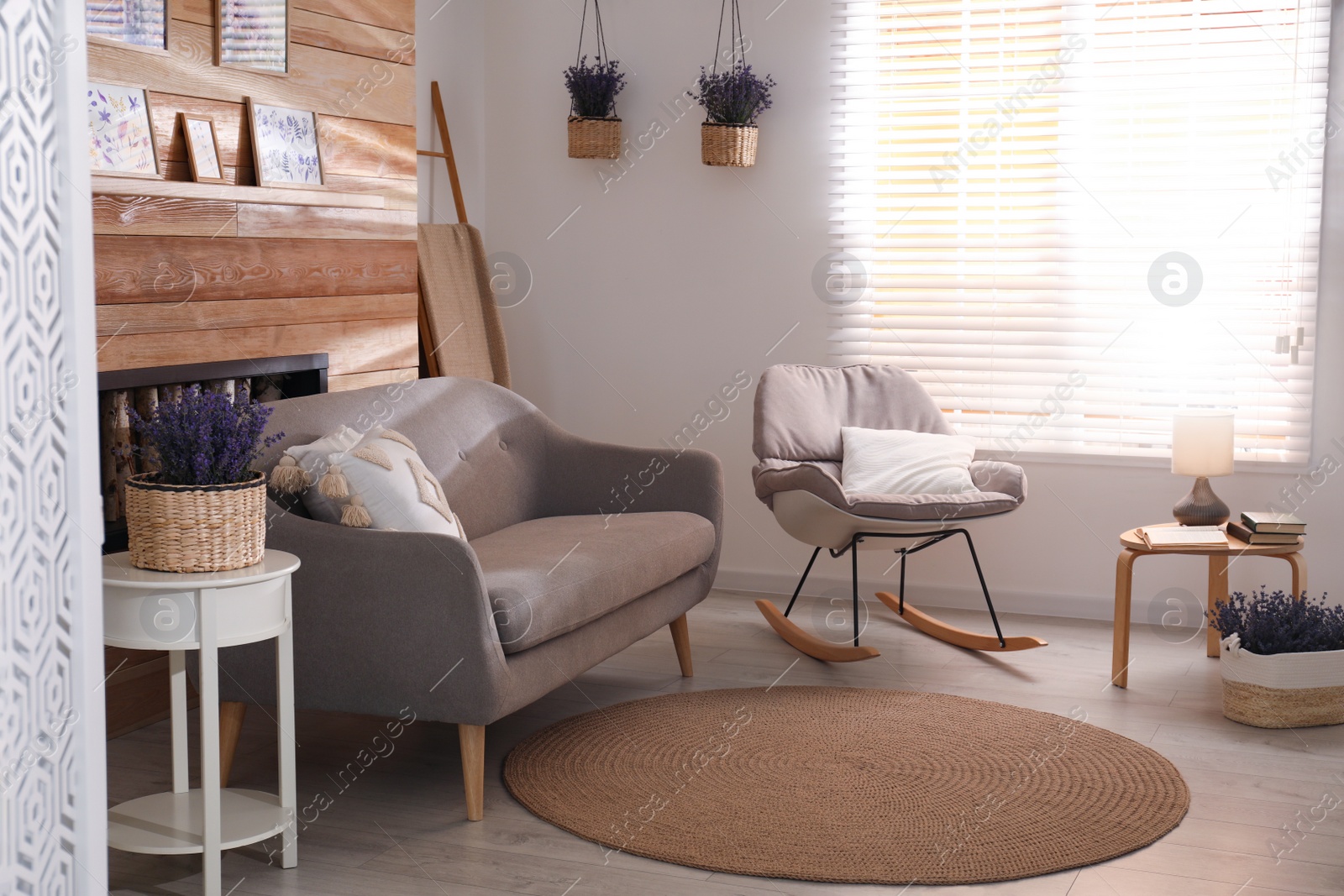 Photo of Stylish sofa and rocking chair in beautiful living room interior