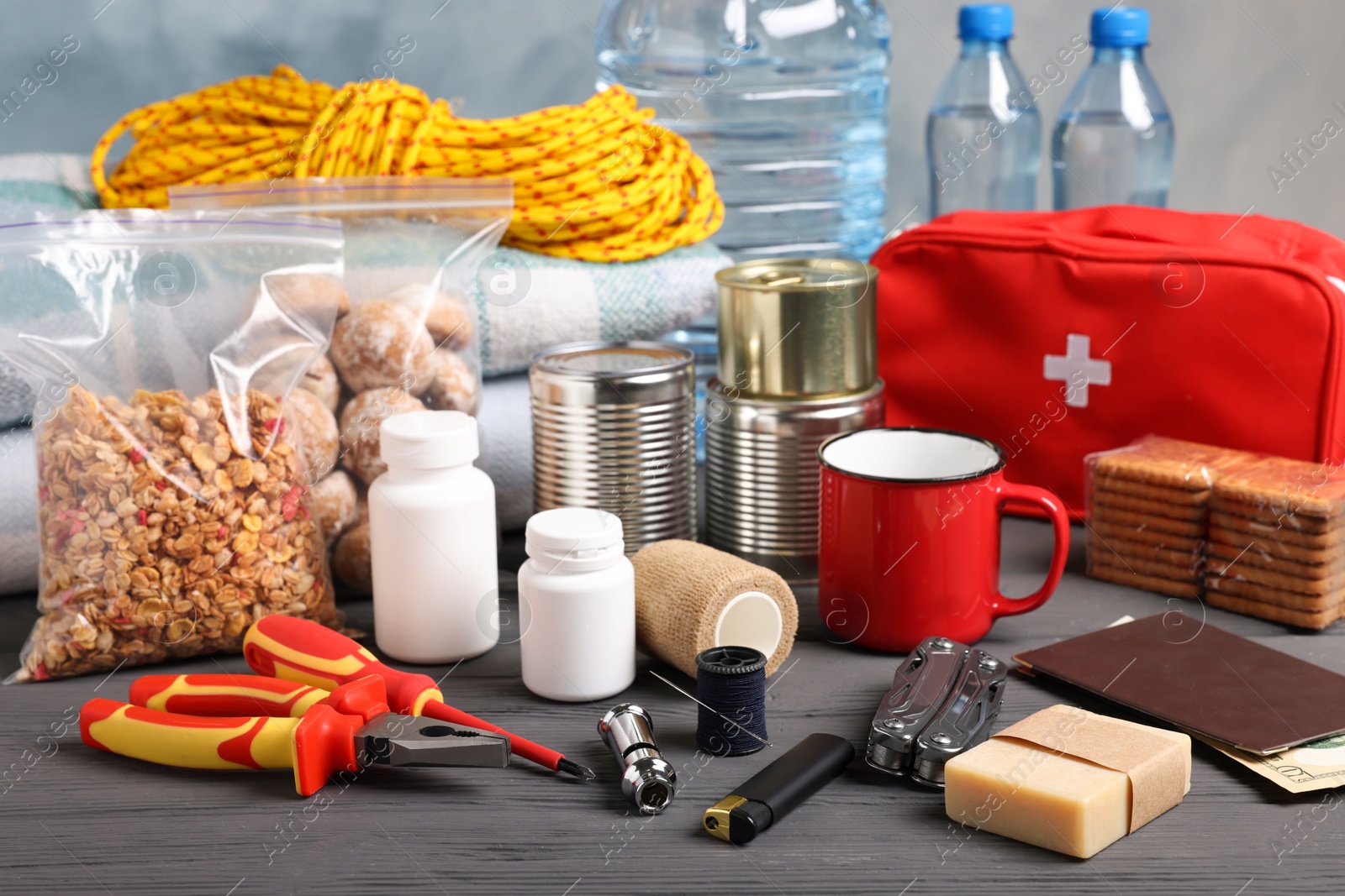 Photo of Disaster supply kit for earthquake on black wooden table