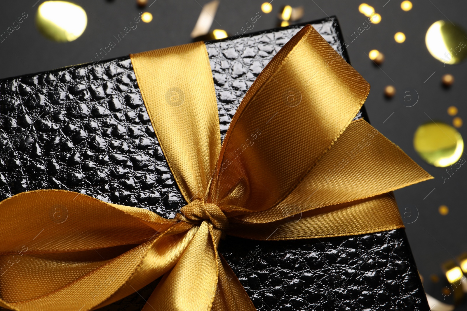 Photo of Gift box with bow on black background, closeup