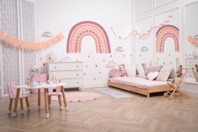 Photo of Montessori bedroom interior with floor bed and toys